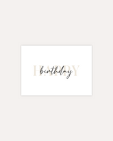 A postcard design consisting of bold beige letters saying "Happy" with black cursive writing on top saying "birthday". The design is shown on a beige background.