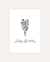 A postcard design showing a line art drawing of a bunch of flowers tied together. Below that is some cursive writing saying "Happy Birthday". The design is shown on a beige background.