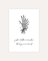 postcard design showing line art drawing of a flower bouquet with little hearts. Below that are two lines of cursive writing saying "Just a little reminder that you are loved". The design is shown on beige background.