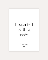 A postcard design reading "It started with a swipe" in the middle and a smaller "I love you" with a small heart in the bottom. All black writing on a white card. The design is shown on a beige background.